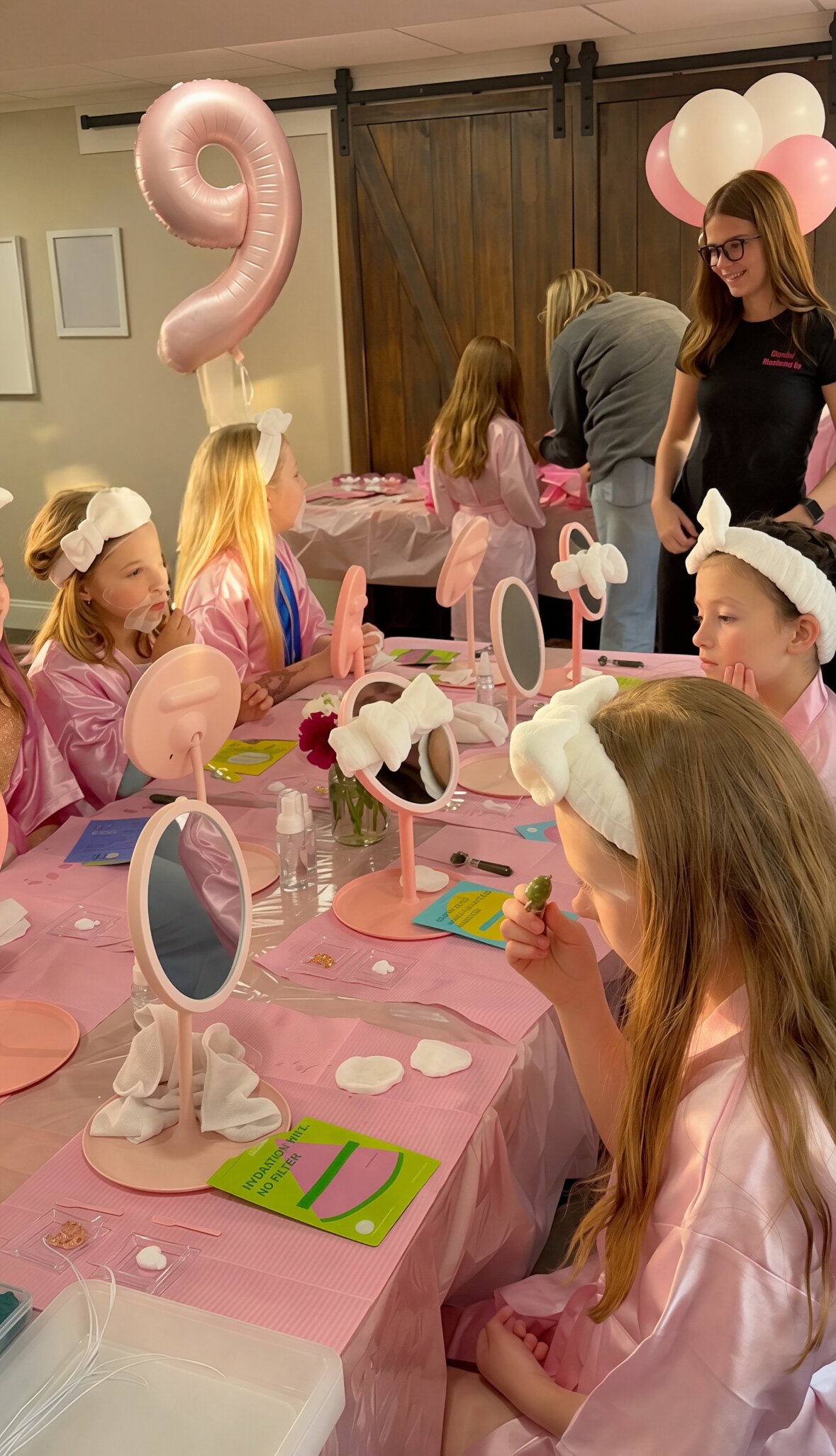 Group of girls in pink spa robes and headbands enjoying facial masks together with a staff member at an Opal Beauty Events kids spa party.