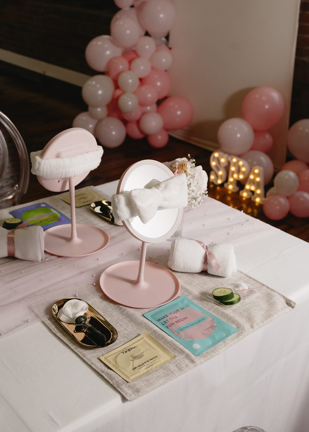 Kids spa birthday party vanity mirror with gold eye patches, face masks and cucumber slices