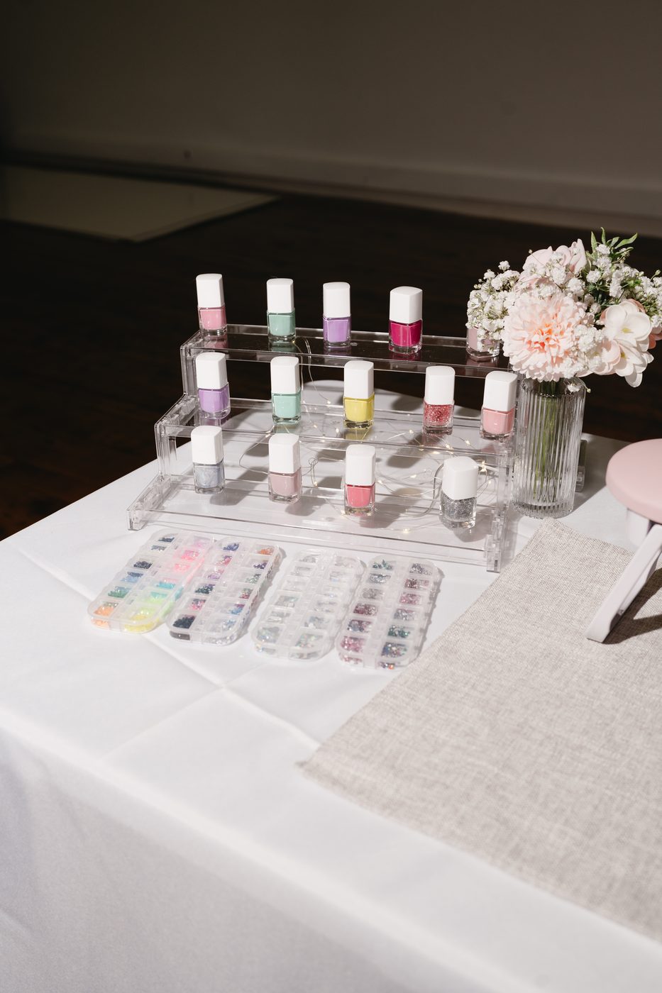 Nail polish and rhinestone bar set up for a kids spa birthday party