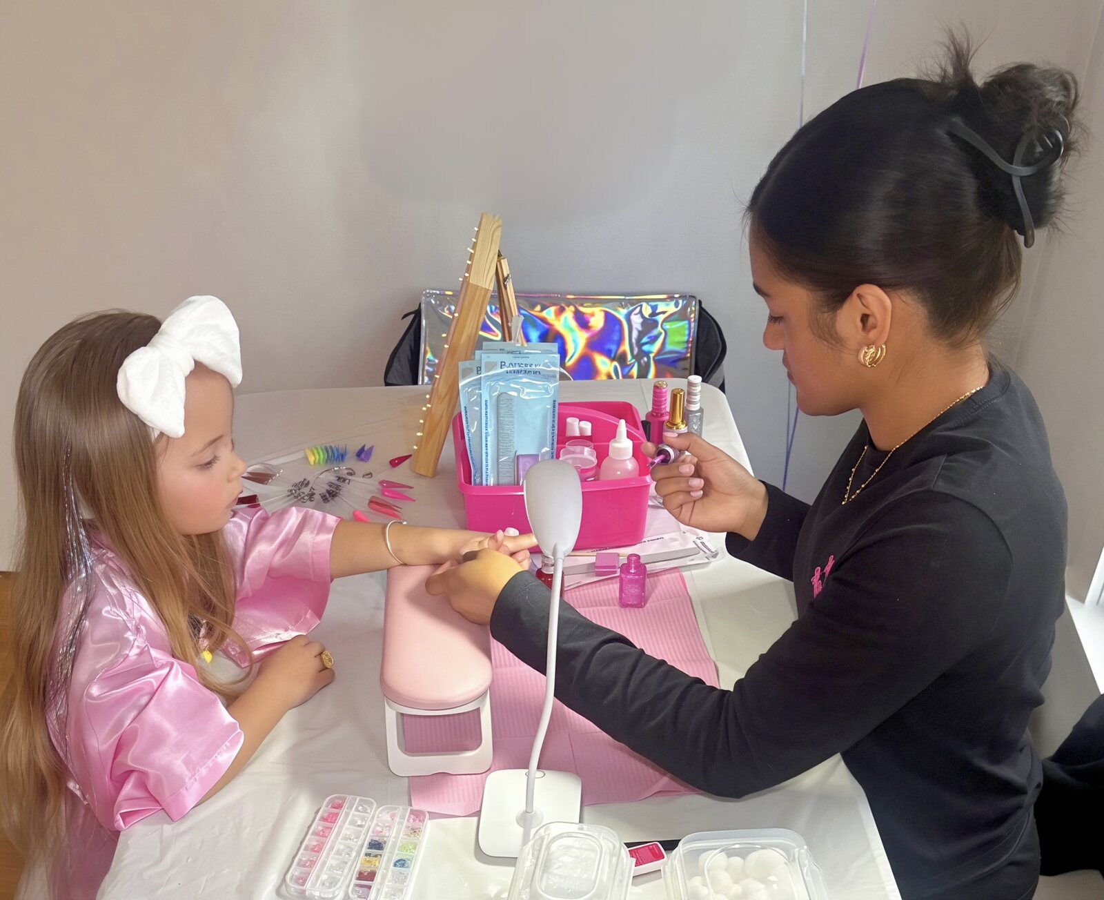 Opal Beauty Events technician giving a young girl a manicure at a kids spa party